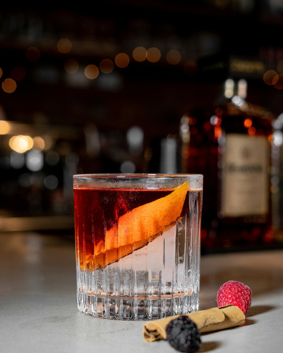 A whiskey cocktail with an orange twist
